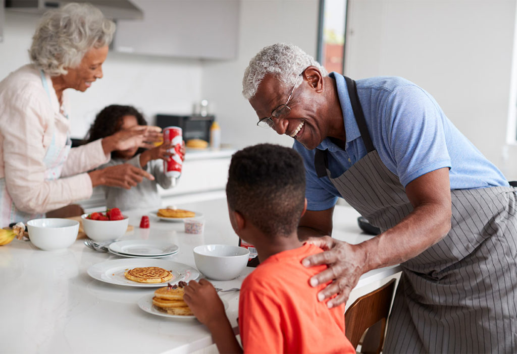 grandparents making breakfast at the kitchen island with their grandkids what are annuities westchester il