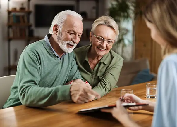 senior couple meeting with financial advisor to discuss active money management in retirement